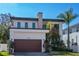 Stunning two-story modern home with a dark brown garage door and lush landscaping at 4604 W Lowell Ave, Tampa, FL 33629