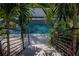 Inviting backyard featuring a pool, spa, lush greenery, and steps for outdoor enjoyment and relaxation at 4604 W Lowell Ave, Tampa, FL 33629