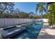 Relaxing backyard pool with a spa, patio, landscaping, and comfortable lounge chairs for enjoying sunny days at 4604 W Lowell Ave, Tampa, FL 33629