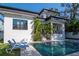 Stunning view of the backyard pool and outdoor living space, showcasing modern architecture and lush landscaping at 4604 W Lowell Ave, Tampa, FL 33629