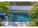 Stunning pool and spa area framed by lush tropical foliage, offering a private oasis with tranquil blue water at 4604 W Lowell Ave, Tampa, FL 33629