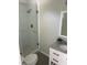 Bathroom featuring a walk-in shower with glass doors, granite countertops, and modern fixtures at 561 Park S St, St Petersburg, FL 33707