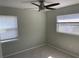 Bedroom featuring plush carpets, a ceiling fan, and large windows with blinds at 561 Park S St, St Petersburg, FL 33707