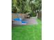 Backyard area with outdoor seating, a patio table set, artificial grass and new privacy fence at 70 Deerpath Dr, Oldsmar, FL 34677