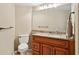 Bathroom featuring granite countertops, wood cabinetry, and a decorative mirror at 70 Deerpath Dr, Oldsmar, FL 34677