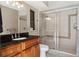 Bathroom featuring a vanity with black countertop and a sliding glass shower door at 70 Deerpath Dr, Oldsmar, FL 34677