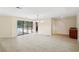 Bright living room featuring tile flooring, sliding glass doors to the pool, and a wet bar area at 70 Deerpath Dr, Oldsmar, FL 34677