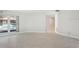Bright living room features tile flooring, white walls, and a view of the outdoor pool at 70 Deerpath Dr, Oldsmar, FL 34677