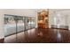 Spacious living room with beautiful dark wood floors, wet bar, and sliding doors to the pool area at 70 Deerpath Dr, Oldsmar, FL 34677