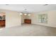 Open living room with tile floors, wet bar and view to bathroom vanity at 70 Deerpath Dr, Oldsmar, FL 34677
