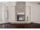 Cozy living room featuring a stone fireplace with hearth, creating a warm and inviting atmosphere at 70 Deerpath Dr, Oldsmar, FL 34677