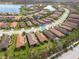 Expansive aerial view of the community showcasing well-maintained homes, lush landscaping, and a serene lake backdrop at 11563 Callisia Dr, Odessa, FL 33556