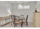 Elegant dining room with a glass-top table, comfortable seating, and decorative lighting fixture at 11563 Callisia Dr, Odessa, FL 33556