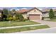 Charming single-story home showcasing a well-manicured lawn and a two-car garage at 11563 Callisia Dr, Odessa, FL 33556