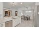 Bright kitchen with stainless appliances and granite counters open to the dining area with stylish light fixture at 11563 Callisia Dr, Odessa, FL 33556