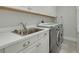 Laundry room with appliances, counter space, a sink, and storage cabinets at 11563 Callisia Dr, Odessa, FL 33556