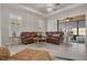 Bright living room featuring a comfortable leather sofa and stylish furnishings with access to lanai at 11563 Callisia Dr, Odessa, FL 33556