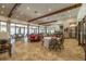 Large meeting room with ample seating, wooden beams, and natural light from the large window views at 11563 Callisia Dr, Odessa, FL 33556