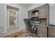 Well-appointed office with custom cabinetry and a view into the ensuite bathroom at 11563 Callisia Dr, Odessa, FL 33556