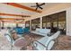 Covered outdoor lounge area with comfortable seating and ceiling fans at 11563 Callisia Dr, Odessa, FL 33556