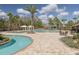 Resort-style community pool with cabanas, ample seating, and lush tropical landscaping for relaxation at 11563 Callisia Dr, Odessa, FL 33556