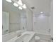Bright bathroom features shower-tub combo, sleek vanity, and modern light fixture at 12779 Fisherville Way, Riverview, FL 33579
