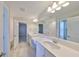 Bright bathroom with double vanity, white countertops and tile floors, perfect for modern living at 12779 Fisherville Way, Riverview, FL 33579
