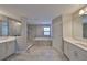 Luxurious bathroom with dual vanities, a soaking tub, and a separate glass-enclosed shower at 12779 Fisherville Way, Riverview, FL 33579