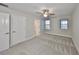 Spacious bedroom featuring neutral tones, ceiling fan, and natural light from two windows at 12779 Fisherville Way, Riverview, FL 33579