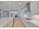 Chef's kitchen with white cabinets, stainless steel appliances, subway tile backsplash, and a large island with a sink at 12779 Fisherville Way, Riverview, FL 33579