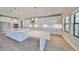 Bright kitchen features white cabinetry, stainless appliances, and a large marble-topped island with seating at 12779 Fisherville Way, Riverview, FL 33579