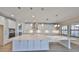 This expansive kitchen features a large quartz island, stainless appliances, and custom cabinets, perfect for entertaining at 12779 Fisherville Way, Riverview, FL 33579