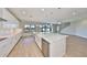 This kitchen has a large island with a breakfast bar, stainless appliances, white cabinets, and an open layout at 12779 Fisherville Way, Riverview, FL 33579