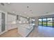 Gourmet kitchen features a large center island with quartz countertops, pendant lighting, and stainless steel appliances at 12779 Fisherville Way, Riverview, FL 33579