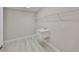 Functional laundry room features utility sink, white wire shelving and light gray wood-look floors at 12779 Fisherville Way, Riverview, FL 33579
