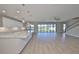 Open living space with kitchen and large sliding glass doors to the outdoors at 12779 Fisherville Way, Riverview, FL 33579