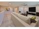 Upstairs living room featuring a large sofa, entertainment system, and contemporary artwork in a bright space at 12779 Fisherville Way, Riverview, FL 33579