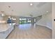 Bright living room boasts an open floor plan, hardwood floors, and sliding glass doors to the backyard at 12779 Fisherville Way, Riverview, FL 33579