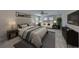 Cozy main bedroom featuring a comfortable bed, sitting area, and large windows with natural light at 12779 Fisherville Way, Riverview, FL 33579
