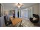 Bright home office with modern desk setup, stylish decor, and comfortable egg chair near frosted french doors at 12779 Fisherville Way, Riverview, FL 33579