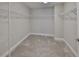 Spacious walk-in closet with ample shelving and carpeted floors at 12779 Fisherville Way, Riverview, FL 33579