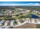 Panoramic aerial view of the neighborhood, showcasing houses, golf course, lakes, and surrounding greenery at 13252 Norman Cir, Hudson, FL 34669