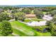 Stunning aerial view of the clubhouse and golf course with lush green landscaping and mature trees at 13252 Norman Cir, Hudson, FL 34669