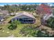 Expansive backyard view featuring a screened patio and lush green lawn, offering a serene outdoor retreat at 13252 Norman Cir, Hudson, FL 34669