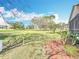 Well-maintained backyard with lush green lawn and privacy border, creating a peaceful outdoor setting at 13252 Norman Cir, Hudson, FL 34669
