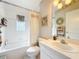 Bright bathroom featuring a shower-tub combo, vanity, and tasteful décor for a clean, classic design at 13252 Norman Cir, Hudson, FL 34669