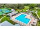 Aerial view of sparkling community pool with lounge chairs, tables, and well-maintained landscaping at 13252 Norman Cir, Hudson, FL 34669