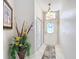 Inviting entryway with tile flooring, decorative floral arrangement, and a frosted glass front door for added privacy at 13252 Norman Cir, Hudson, FL 34669