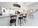 Open-concept kitchen with a breakfast bar, offering bar stool seating and seamless transition to the adjacent living area at 13252 Norman Cir, Hudson, FL 34669