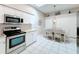 Bright eat-in kitchen featuring modern stainless steel appliances, plenty of storage, skylight, and tile flooring at 13252 Norman Cir, Hudson, FL 34669
